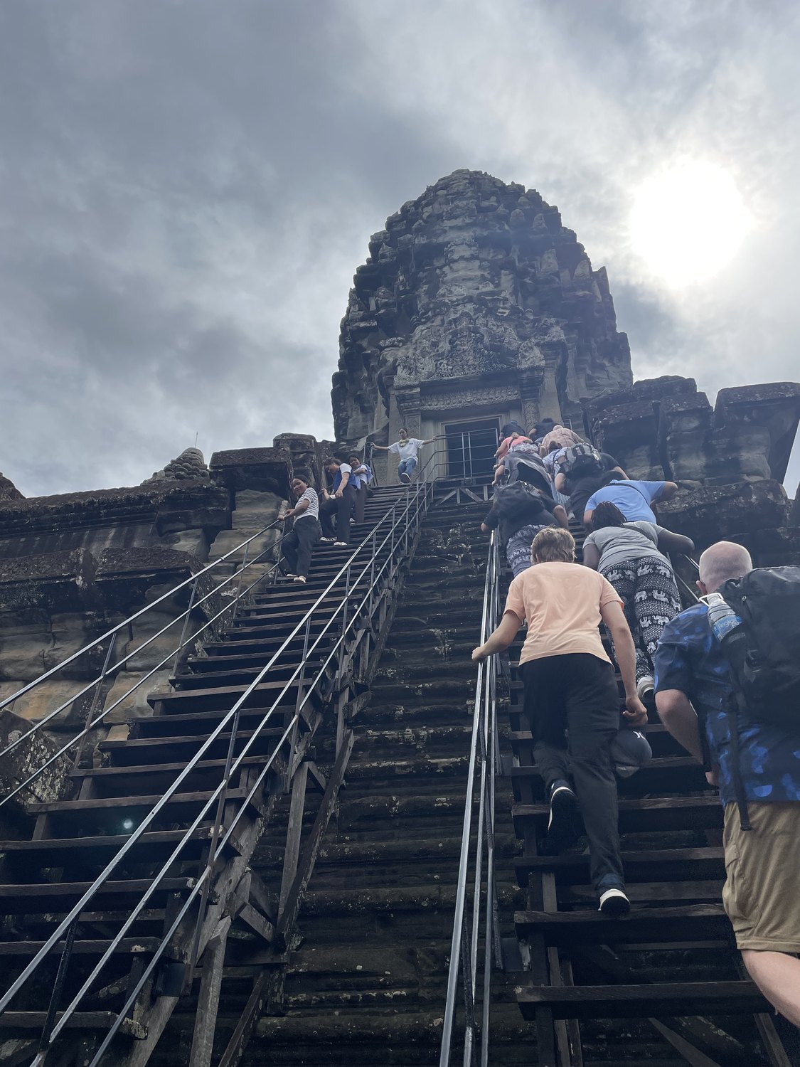 Climbing the steps at Angkor Wat